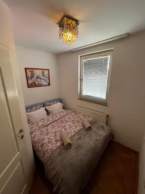 a bedroom with a bed with two shoes on it at Nataša in Doboj