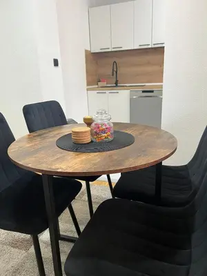 a wooden table with a bowl of food on it at EMMA apartman in Travnik