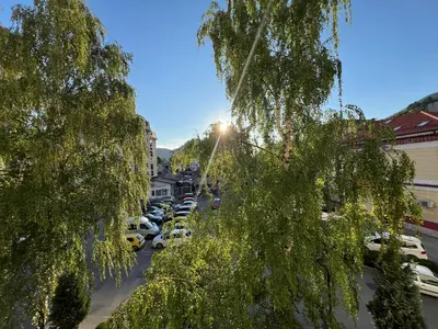 a street with cars parked in a parking lot at EMMA apartman in Travnik