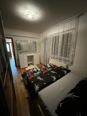 a bedroom with a large bed and a window at Beauty Room Apartman in Prnjavor