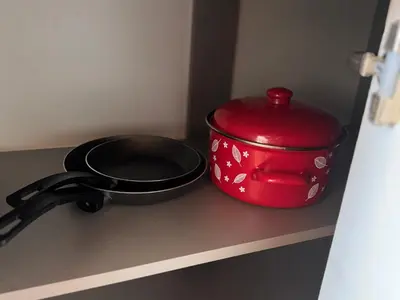 a red pot and a pan on a counter at Beauty Room Apartman in Prnjavor