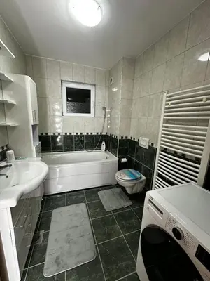 a bathroom with a tub and a toilet and a sink at Beauty Room Apartman in Prnjavor
