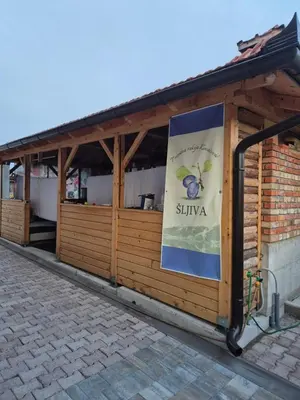a building with a sign on the side of it at Sobe Kovacevic