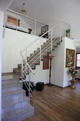 a staircase in a house with a stair case at Villa Duboka Bugojno in Bugojno