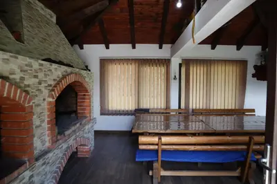 an empty church with a brick fireplace and benches at Villa Duboka Bugojno in Bugojno