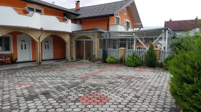 a house with a stone patio in front of it at 4 Room - 2 story Apartment Kuckovic in Bihać