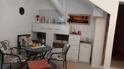 a kitchen with a table and chairs and a fireplace at 4 Room - 2 story Apartment Kuckovic in Bihać