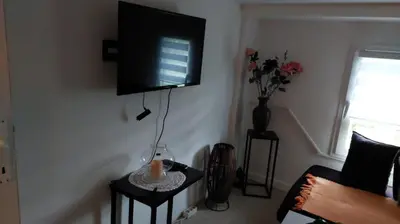 a living room with a flat screen tv on a wall at 4 Room - 2 story Apartment Kuckovic in Bihać