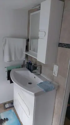 a bathroom with a white sink and a mirror at 4 Room - 2 story Apartment Kuckovic in Bihać