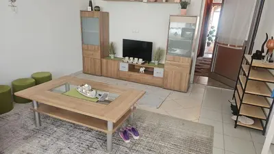a living room with a coffee table and a tv at 1 Room Suite Kuckovic in Bihać