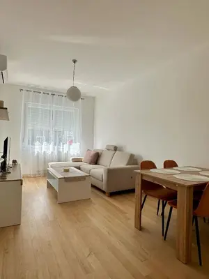 a living room with a couch and a table at Ada by AA Stan na dan in Železnička Stanica Incel