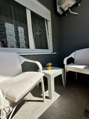 a room with two chairs and a bench and a window at Ada by AA Stan na dan in Železnička Stanica Incel