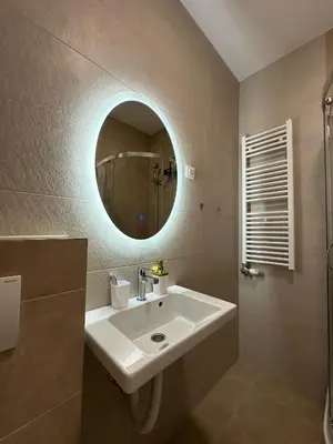 a bathroom with a sink and a mirror at Ada by AA Stan na dan in Železnička Stanica Incel