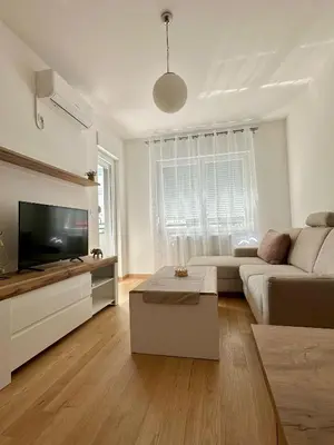 a living room with a couch and a flat screen tv at Ada by AA Stan na dan in Železnička Stanica Incel