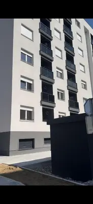 a tall building with balconies on the side of it at Ada by AA Stan na dan in Železnička Stanica Incel
