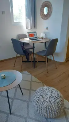 a room with a table with chairs and a laptop at MALA KOLA - Weekend House in Banja Luka