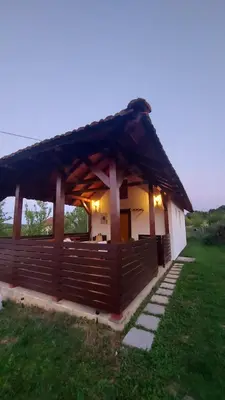 a small house with a thatched roof at MALA KOLA - Weekend House in Banja Luka