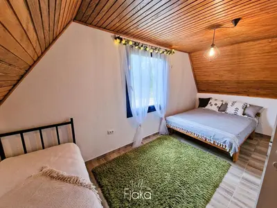 a small bedroom with a bed and a window at Villa Fjaka in Banja Luka