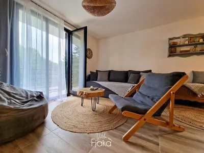 a living room with a chair and a couch at Villa Fjaka in Banja Luka