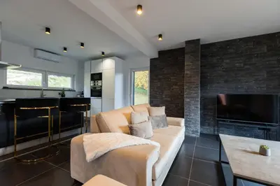 a living room with a couch and a tv at NADA Home in Čelebić