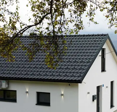 a house with a black roof at NADA Home in Čelebić