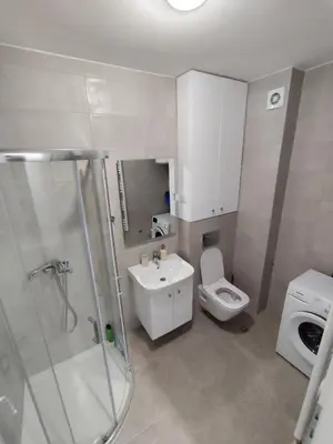 a bathroom with a shower and a toilet and a sink at AnyBL03 in Železnička Stanica Incel