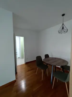 a dining room with a wooden table and chairs at AnyBL03 in Železnička Stanica Incel