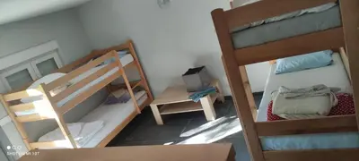 a small room with two bunk beds and a chair at IvanA vikendica,Krupa na Vrbasu in Banja Luka