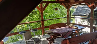 a view of a porch with a table and chairs at IvanA vikendica,Krupa na Vrbasu in Banja Luka
