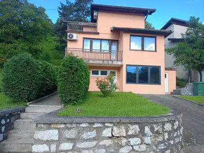 a house with a stone wall in front of it at Villa in Breza Village