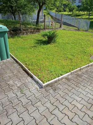 a brick yard with a grassy yard with a trash can at Villa in Breza Village