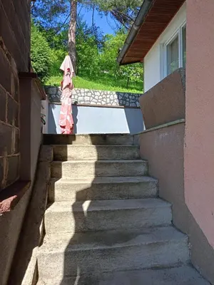 a person standing on stairs with an umbrella at Villa in Breza Village