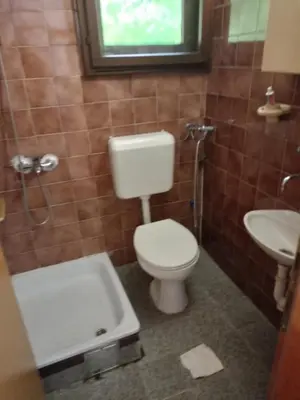 a bathroom with a toilet and a sink at Villa in Breza Village