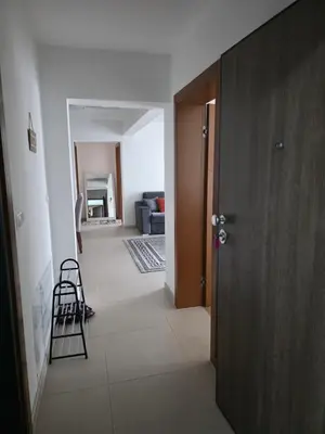a hallway with a door and a stool in a room at Apartment Real 1 in Bugojno
