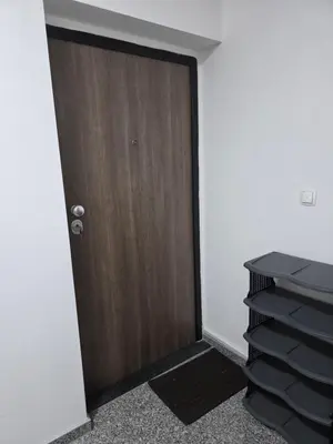 a wooden door in a room with a pile of folders at Apartment Real 1 in Bugojno