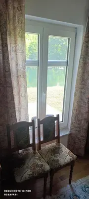 a table and two chairs in front of a window at Holiday home una in Bosanska Krupa