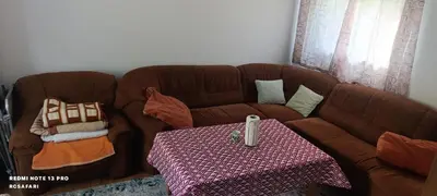 a brown couch with a table in a living room at Holiday home una in Bosanska Krupa