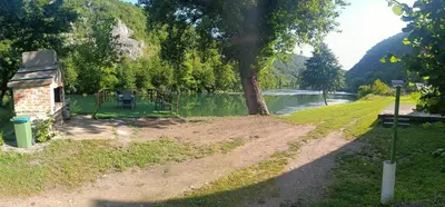 a path next to a river with a tree at Holiday home una in Bosanska Krupa
