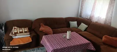 a brown couch with a table in a living room at Holiday home SaFari in Bosanska Krupa