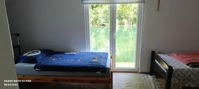 a bedroom with a bed next to a window at Holiday home SaFari in Bosanska Krupa
