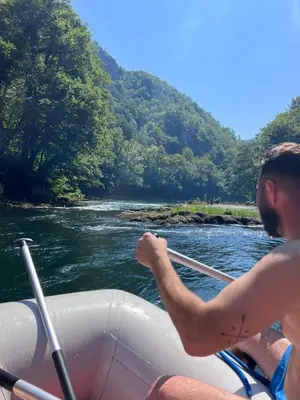 a man riding in a boat on a river at Holiday home SaFari in Bosanska Krupa