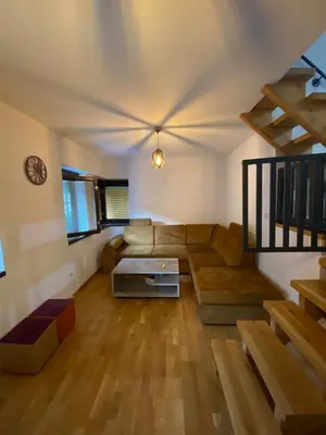 a living room with a couch and a table at Vares Luxury Apartment in Vareš