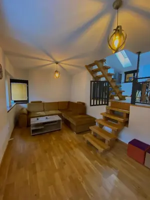 a living room with a couch and a staircase at Vares Luxury Apartment in Vareš