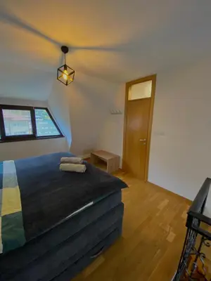 a bedroom with a bed and a window at Vares Luxury Apartment in Vareš