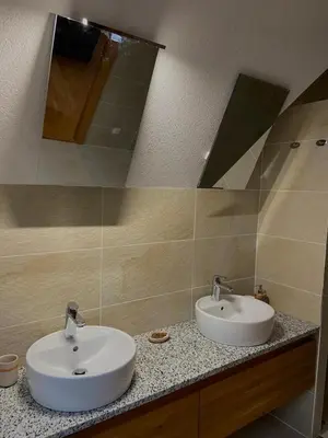 a bathroom with two sinks and a mirror at Vares Luxury Apartment in Vareš