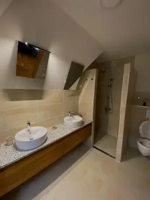 a bathroom with two sinks and a shower at Vares Luxury Apartment in Vareš