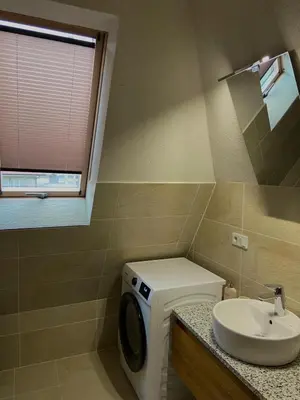 a bathroom with a washing machine and a sink at Vares Luxury Apartment in Vareš