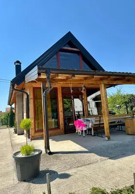 a wooden house with a swing in front of it at Dabar kuca za odmor in Banja Luka