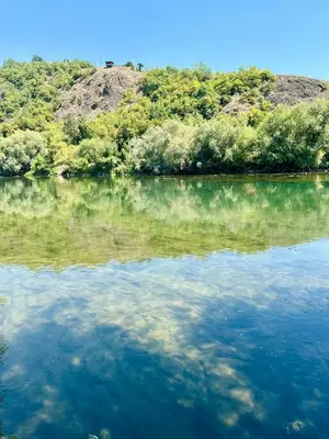 a large body of water with trees in the background at Dabar kuca za odmor in Banja Luka