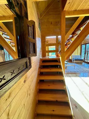a staircase in a cabin with wooden walls and ceilings at Dabar kuca za odmor in Banja Luka